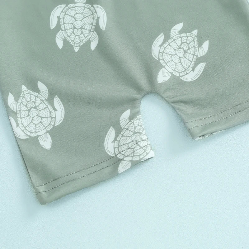 Baby boys rash guard set with turtle and dinosaur print from Baby Bubble, featuring colorful, lightweight swimwear for infants.