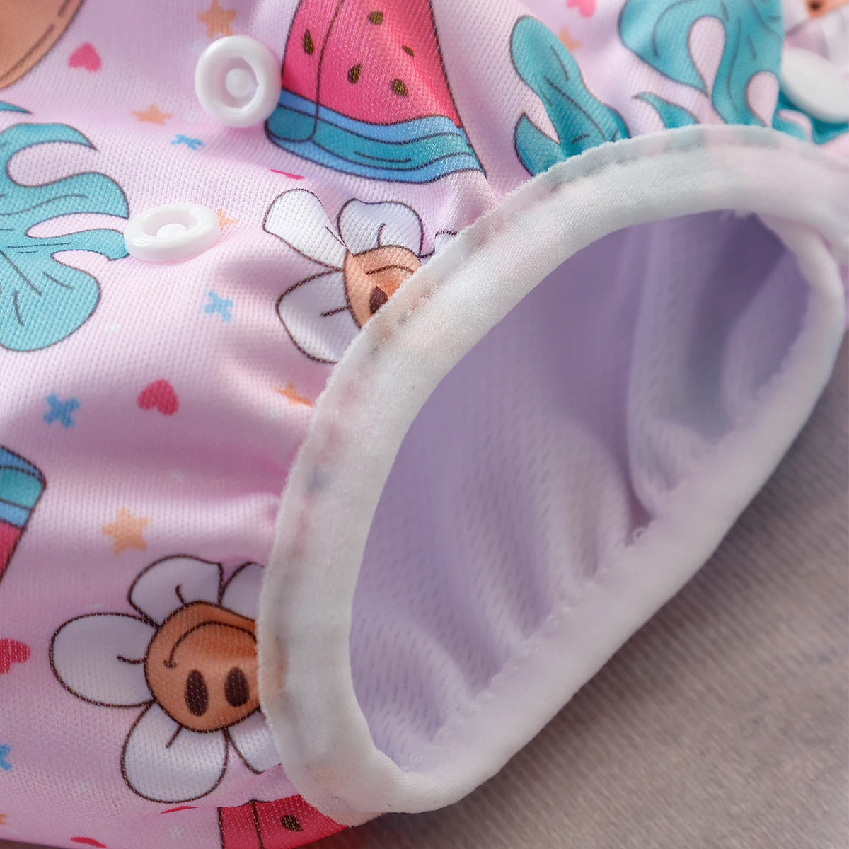 Baby Bubble washable, adjustable baby swim diapers with a snug fit, shown in a colorful design for infants and toddlers.