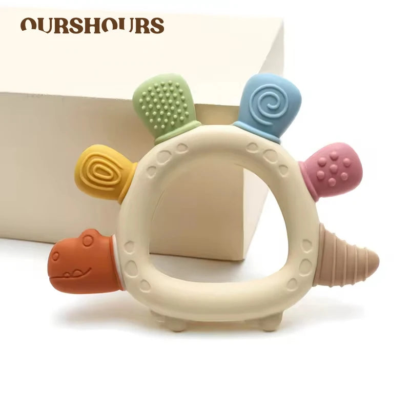 Baby dinosaur-shaped BPA-free teether from Baby Bubble with easy grip design for gum relief and soothing relief for infants.