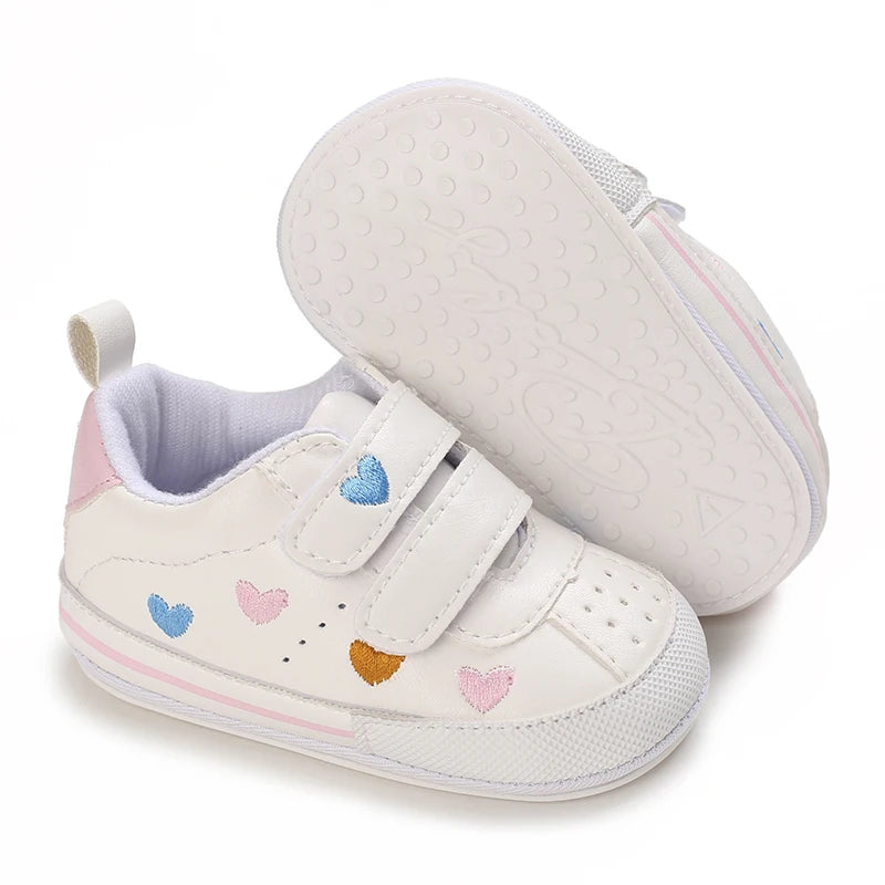 Baby girl soft sole crib shoes by Baby Bubble, designed for first walkers, shown in a close-up image of the soft leather shoes.