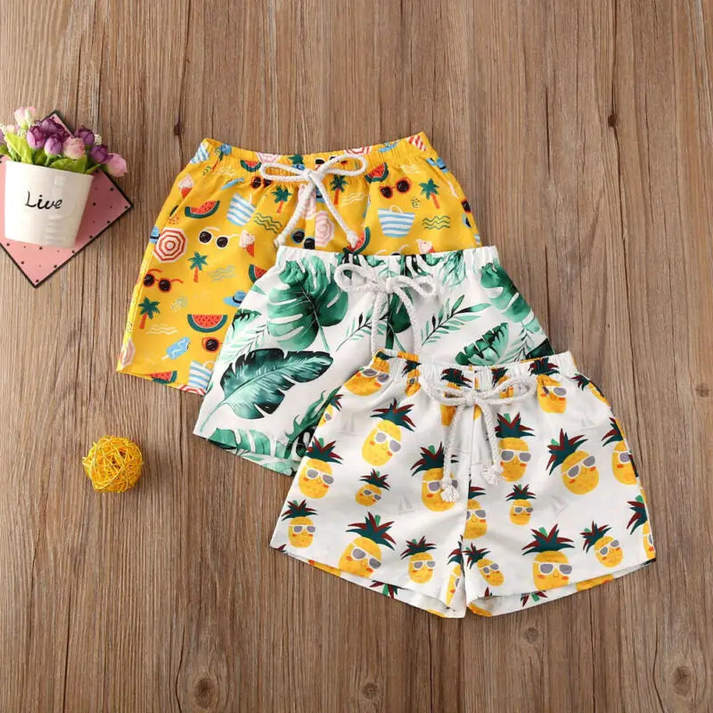 Kids swim shorts by Baby Bubble featuring quick-dry fabric and UV protection, shown in vibrant colors suitable for outdoor swimming.