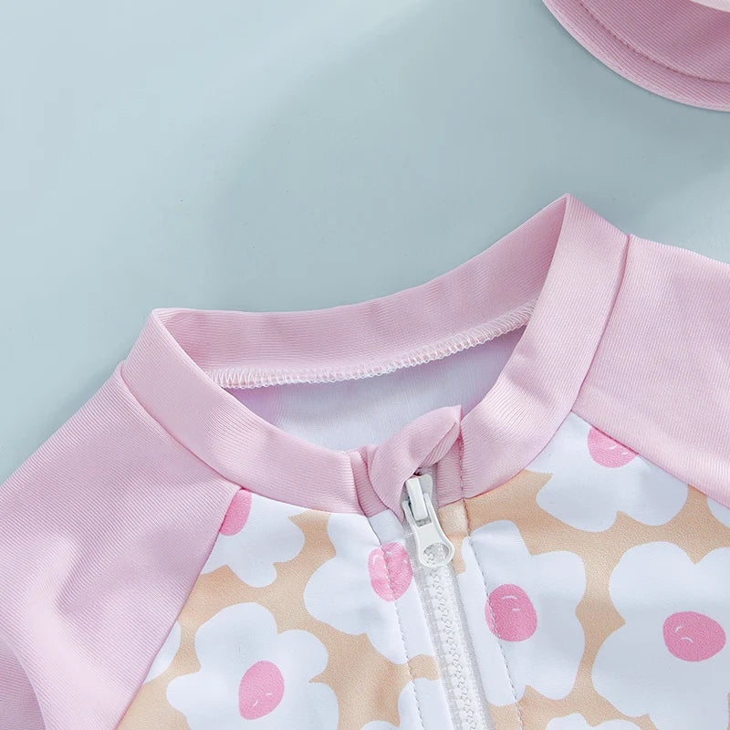 Baby Girl's rash guard set by Baby Bubble with floral and flamingo print, featuring a protective swim top and matching bottoms.