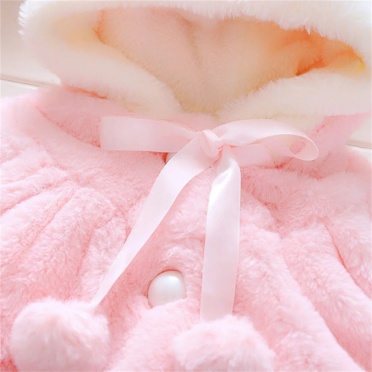 Children's wool cape and fleece jacket by Baby Bubble, featuring a cozy wool cape with ear fleece for warmth and comfort.