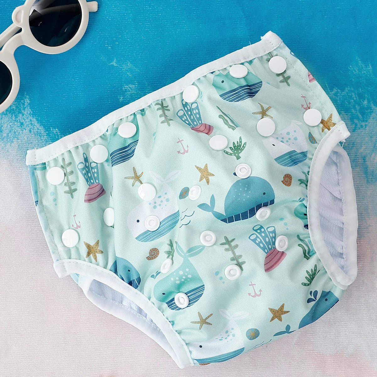Reusable Baby Swim Diapers with colorful animal print by Baby Bubble, designed for comfortable aquatic wear for babies.